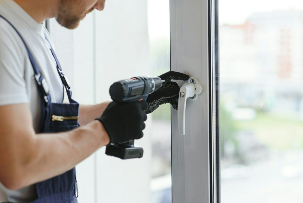 service man installing window with measure tape